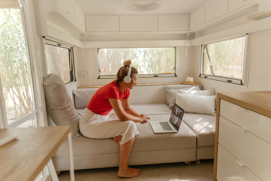 Woman in an RV using her laptop on her mobile internet connection 